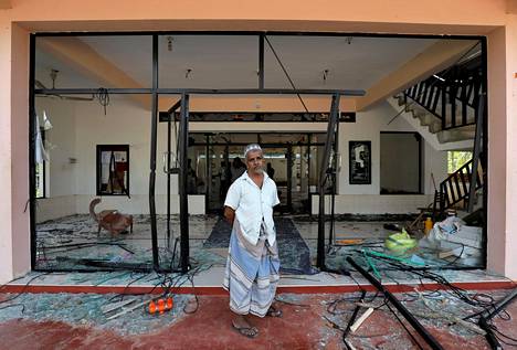 Muslimimies seisoi väkijoukon hyökkäyksen kohteeksi joutuneen moskeijan edustalla Kiniyamassa Sri Lankassa maanantaina.