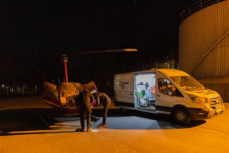 The copter used by GridJet is not large.  Pilot Oskari Pylkkänen (left) and thermal camera operator John Baker adjust the helicopter's camera equipment before taking off.