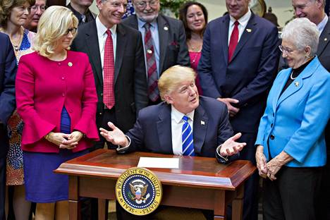 President Donald Trump, who served in office for a week, met with congressmen at the White House on Jan. 27, 2017. On his right is North Carolina Republican Virginia Foxx and on his left is Liz Cheney of Wyoming, who just started in Congress.