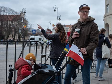 Pyotr Sladowski said recent events have led him to believe in the unity of NATO.  In addition to the Ukrainian flag, he had a Polish flag in the stroller with a symbol depicting the fight.