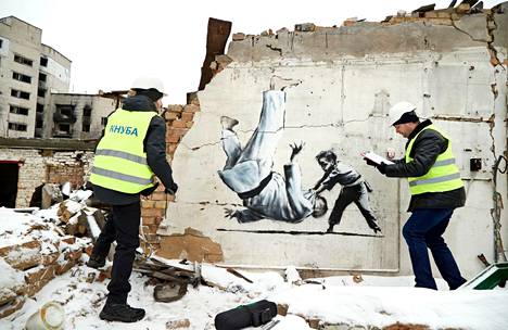 Professor Oleksandr Molodid (right) and his colleague Ivan Musyjaka did a condition survey of Banksy's murals at the ruins of Borodjanka in December 2022.