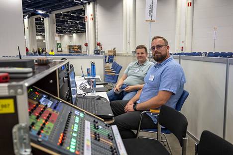 Swedish-speaking Pekka Repo (behind) and Johan Suomi take care of sound technology in the Swedish-speaking hall.  The event is divided into five different areas based on language: Finnish, Swedish, Russian, English and sign language areas.  According to the organizers, there are participants from more than 30 countries.