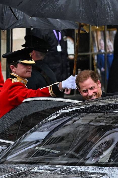 Prinssi Harry hymyili mennessään auton kyytiin. Kruunajaisia juhlittiin lauantaina sateisessa säässä.