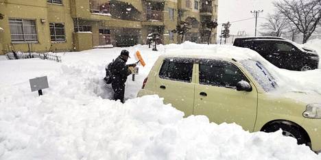 A man dug a car out of the snow in Kitami, Hokkaido Prefecture, on Christmas Eve.