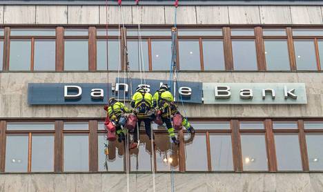 Työmiehet korjasivat Danske Bankin kylttiä Tukholmassa kesällä. Sunnuntain ongelmat olivat verkon puolella.