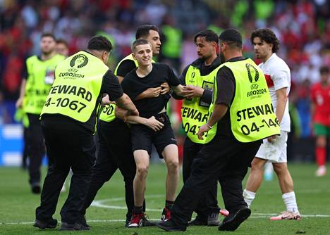 The security guards had to escort a total of six spectators off the field on Saturday.