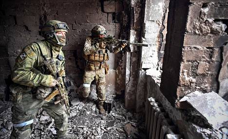 Russian soldiers patrolled the ruined theater building in Mariupol on Tuesday.