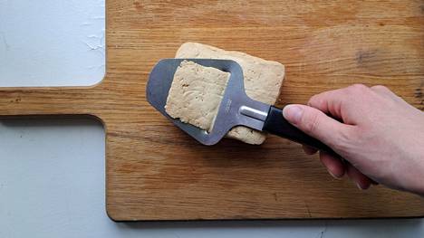 From the tofu piece, you can use a cheese grater to cut thin slices on top of the bread.