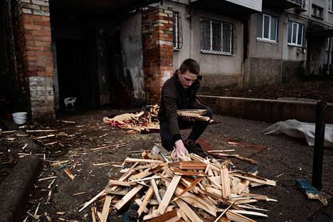 The young man, who introduced himself as Ruslan, chopped firewood in the yard of an apartment building in Krasnogorovka on Friday.