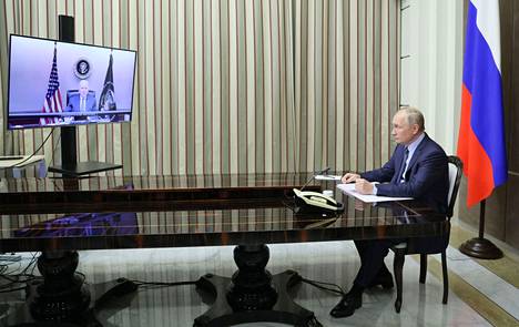 Presidentti Vladimir Putin (oik.) ja presidentti Joe Biden (ruudulla) tapaamisessa tiistaina.