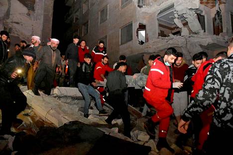 Rescue workers on Monday in Hama, Syria.