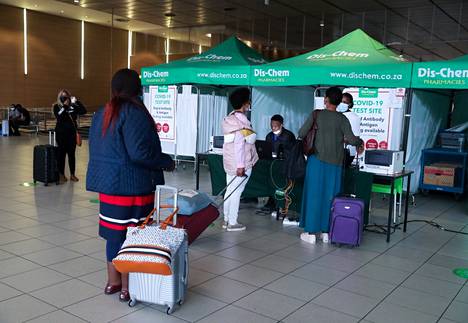 Matkustajat jonottivat koronavirustestiin O.R. Tambon kansainvälisellä lentokentällä Johannesburgissa perjantaina. 