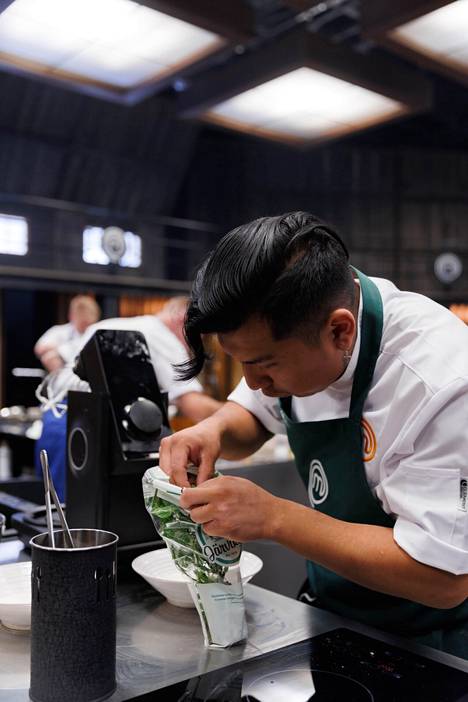 Chef Favio Paz adds herbs to his dish.