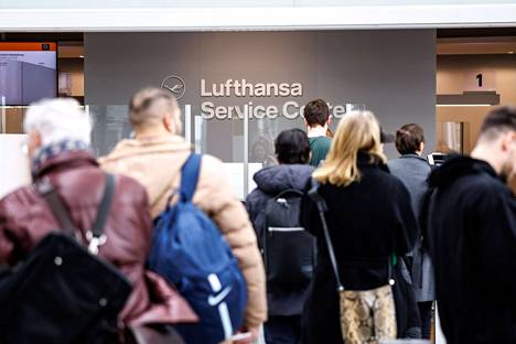 Matkustajat jonottivat Lufthansan palvelutiskille Münchenissä keskiviikkona.