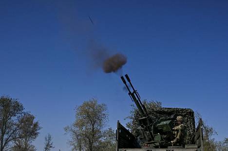 An anti-aircraft gun shoots at a Russian drone near the front line in Zaporizhia, Ukraine, in September.