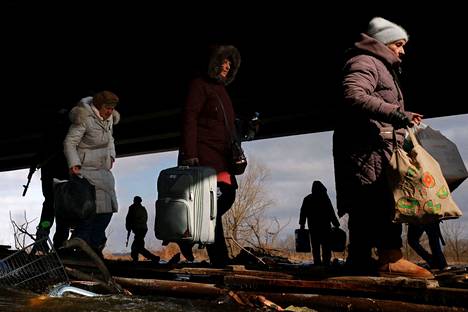Residents fled Irpin on March 9, walking along planks under a destroyed bridge.