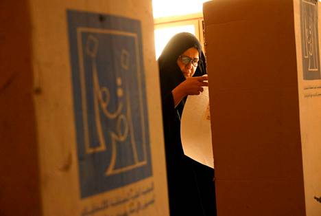 A woman examined a ballot at a polling station in Baghdad.
