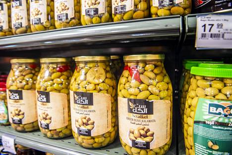 Olives have their own row of shelves.  The selection includes black, green and variously marinated. 