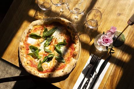 The pizzas are baked for a minute or a half in a pizza oven at almost 500 degrees.  The pizza in the picture is a margherita.