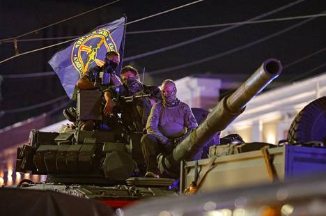 Fighters of the Wagner mercenary group on top of an armored vehicle retreating from Rostov-on-Don.