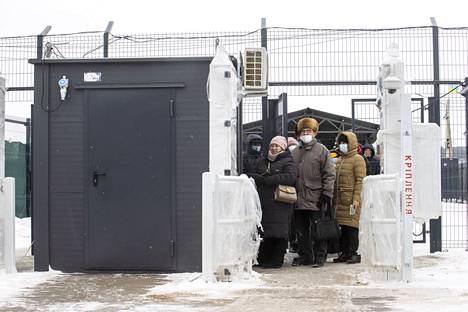 Yevgeny Vyskubin (center), who lives in a village on the Russian-backed separatist side in the Luhansk region, was queuing at the checkpoint on the Ukrainian side to apply for his pension.