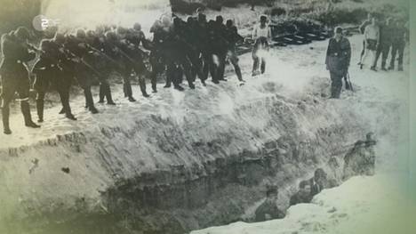 The Nazis executed Jews by shooting directly into mass graves.  Image from Ganz normale Männer.