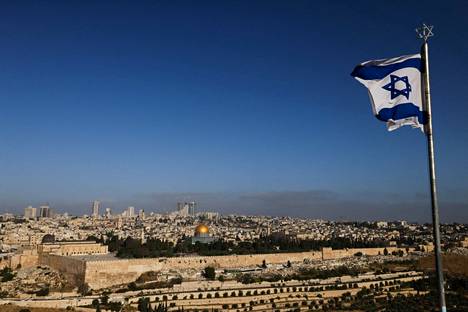The Israeli flag flew in Jerusalem on Friday.  Al-Aqsa Mosque can be seen in the center of the picture.