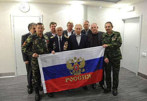 Venäjän presidentti Vladimir Putin poseeraa Afganistanin-sodan veteraanien kanssa Afganistanista vetäytymisen 25-vuotismuistotilaisuudessa Sotšissa helmikuussa 2014.