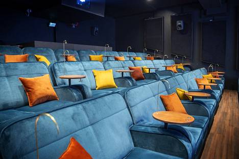 In the movie theater, we curl up on turquoise sofas.