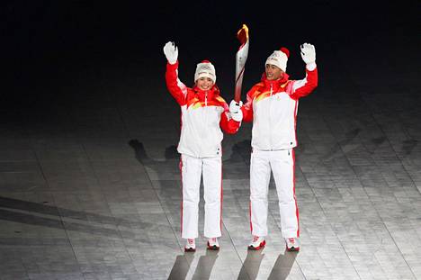 Dinigeer Yilamujiang carried a torch at the opening ceremony of the Olympics along with Chinese combined athlete Zhao Jiawe. 