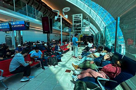 People wait for their flights at Dubai International Airport on Wednesday.