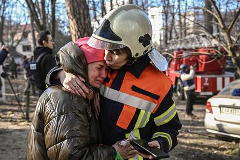 A rescue worker comforted a resident evacuated from a bombed-out apartment building in Kiev on Tuesday.
