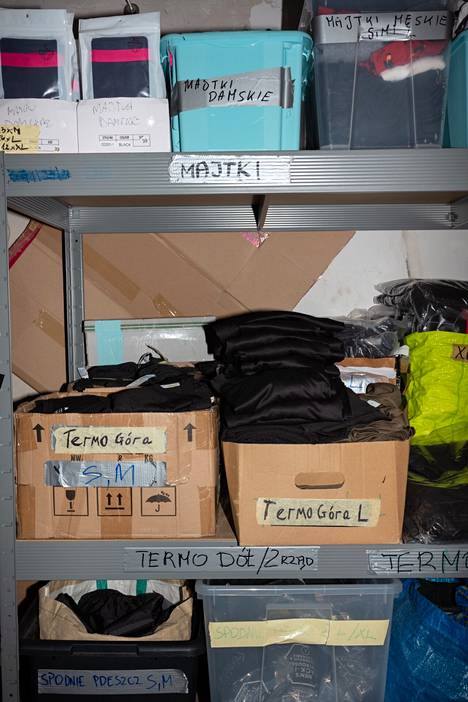 The aid organization has warm clothes for migrants in its warehouse.