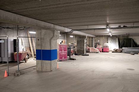 The car park is located under unfinished buildings.  It is also unfinished in its condition. 