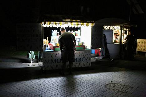 A man shops at a kiosk on the dark Lanzheronovskaya street in Odessa, southern Ukraine, on July 4.