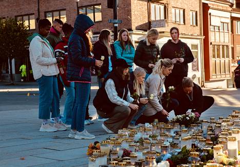 A group of students dropped candles at the memorial site on Friday.