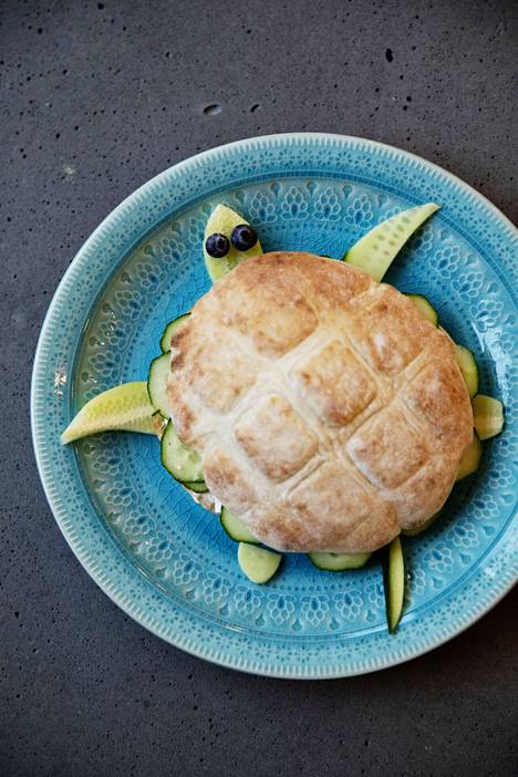 Turtle.  Fill the bun the way you want and place on a plate.  Put one grape on the head of the turtle and four on the legs.