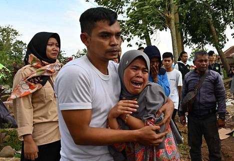 Relatives mourned 48-year-old Husein at his funeral on Tuesday.  He died after he was building a house in a village near the city of Cianjur at the time of Monday's earthquake.