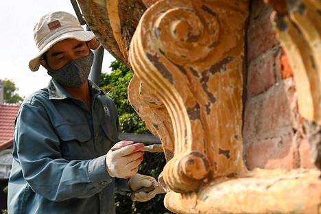 A worker repaired an old villa in Hanoi in November 2022.