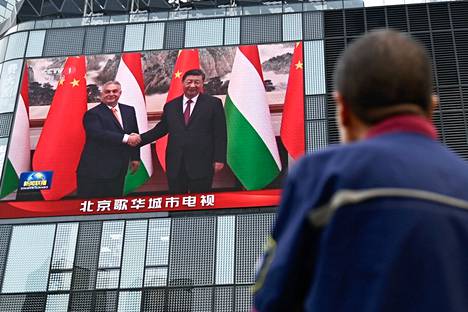 A man was watching a large TV screen in Beijing, which was showing news footage of the meeting between Hungarian Prime Minister Viktor Orbán and Chinese President Xi Jinping on Monday.