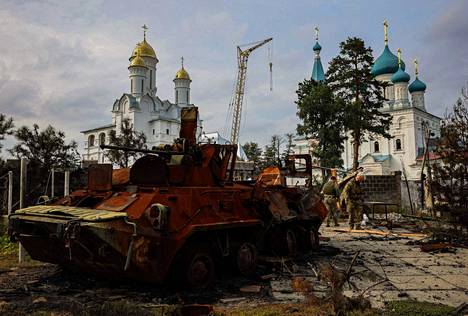 Tuhottu venäläinen miehistönkuljetusvaunu on jäänyt ortodoksikirkon viereen Svjatohirskin lähellä Donetskin alueella.