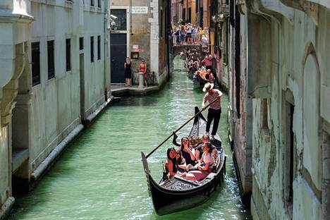 A gondolier transports people in Venice, Italy on July 15.