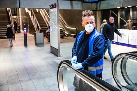 Työntekijä desinfioi Kööpenhaminan metron liukuportaita tiistaina.