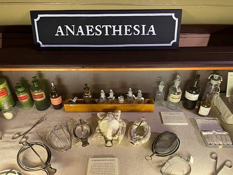 In the foreground is the museum’s collection of anesthesia masks from the late 19th and early 20th centuries.  Old ether and chloroform bottles in the background.
