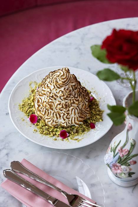 Oven ice cream flavored with lemon paste rests on a bed of pistachios.