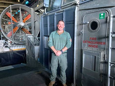Howard Young's tool is a huge hovercraft.  He is standing next to one such cockpit, the propeller behind belongs to another similar one. 