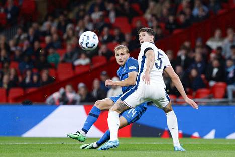 Topi Keskinen (left) tried to get past England's topper John Stones.