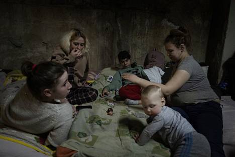 Families with children are coloring in a bomb shelter under a children’s hospital.