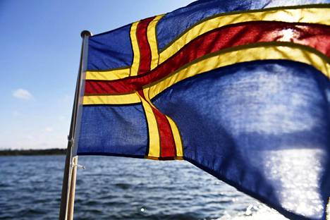 Ahvenanmaan lippu liehuu veneessä.