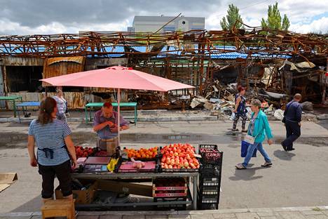 Torimyyjä myi hedelmiä tuhoutuneen kauppahallin edessä Donetskissa lähellä rautatieasemaa 22. heinäkuuta. 